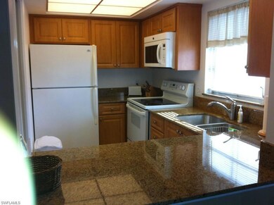 Kitchen featuring white appliances, a sink, and br