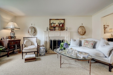 Left unit: Charm galore in the living room with hardwood floors, crown molding and fireplace with beautiful mantle.