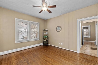 view of dining area & hallway leading to bathroom, kitchen & primary becroom