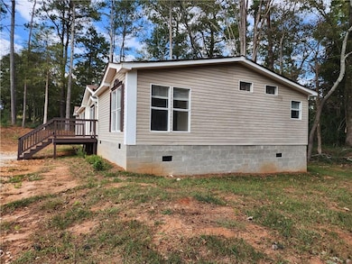 View of side of home with a wooden deck