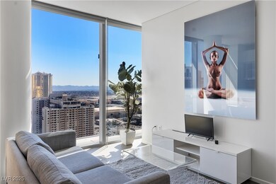 Living room with a city view, a wall of windows, a
