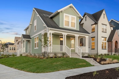 View of front of home with a front yard, roof with shingles, and a porch