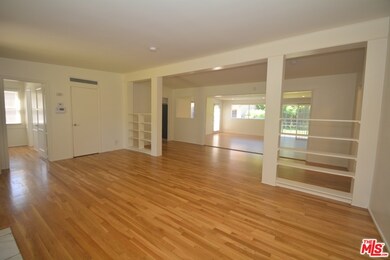 Hardwood floors, fireplace, shelving warm up the h