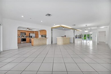 Large family room open to kitchen with built-in ba