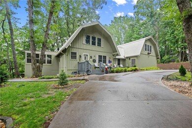 Dutch colonial with a gambrel roof and curved driveway