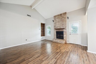 Unfurnished living room featuring wood finished f