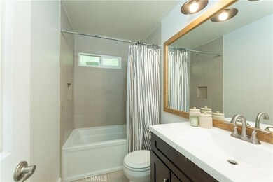 Remodeled bathroom with newer vanity, tiled shower and flooring.