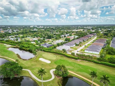 Aerial view of residential area with a golf club and a nearby body of water