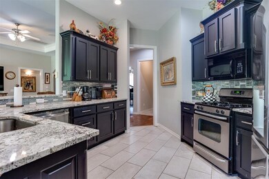 Kitchen with decorative backsplash, granite counte