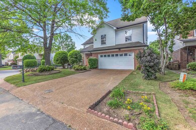 Traditional-style home featuring a garage, brick s