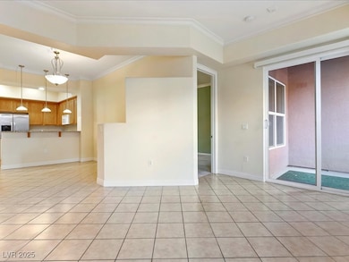 Unfurnished living room with crown molding, light