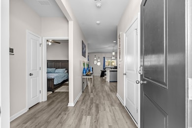 Hall featuring light wood-type flooring and baseboards