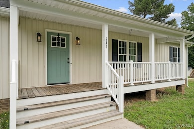 View of exterior entry with a porch
