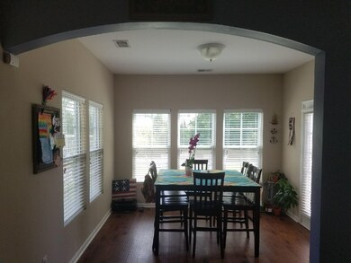 Open sun room has lots of windows.