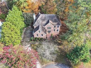 View of subject property featuring a heavily wooded area