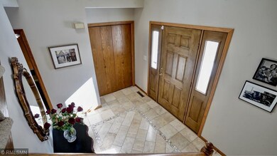 Bright two story entry with custom travertine marb