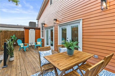 Expansive back deck with double French doors to th