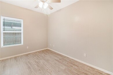 Empty room featuring ceiling fan and light wood-type flooring
