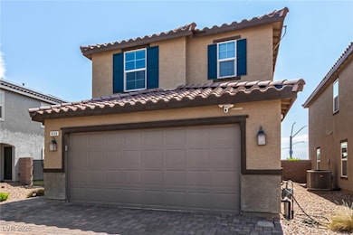 View of front of house with a tile roof, an attach