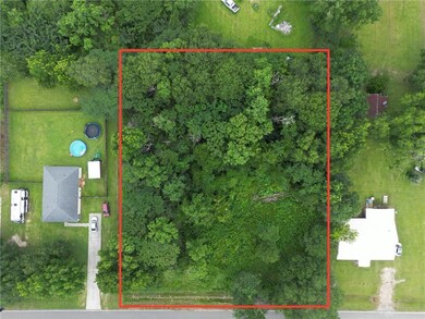 Aerial view of property and surrounding area with property parcel outlined