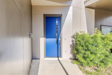 View of exterior entry featuring stucco siding