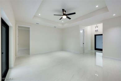 This spacious living room features elegant tray ce