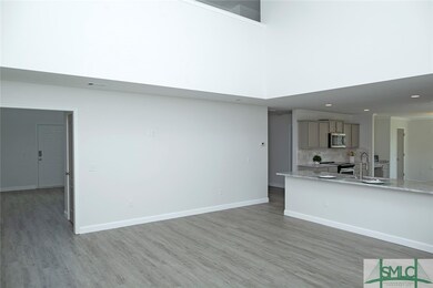 Spacious living room opens to the island kitchen.