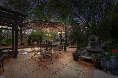 Jaw-dropping patio with a fountain and fireplace!