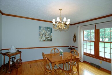 A double window, wood floors and chair rail are am