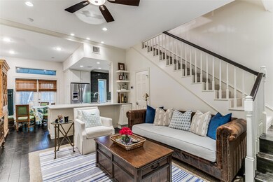 Living room featuring ceiling fan, dark hardwood /