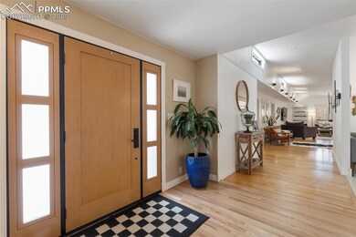 Entryway with light wood-type flooring and baseboards