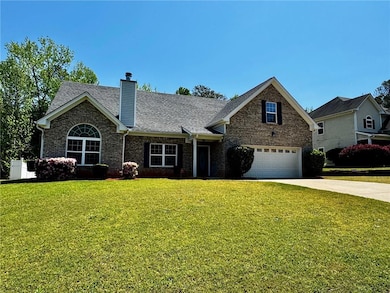 View of front of property with driveway, a chimney