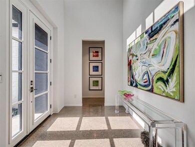 Hall with baseboards, french doors, and speckled floor