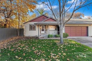 View of front of property with concrete driveway, covered porch, a shingled roof, and a garage