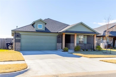 View of front of property featuring a garage and covered porch