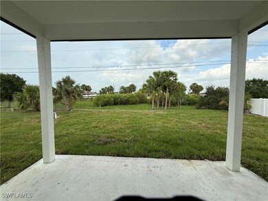 View of green lawn with a patio area