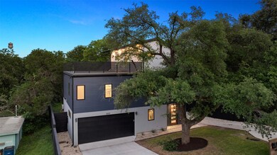View of front facade featuring a front yard, a ga