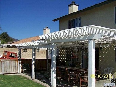 Rear yard divided has nice covered patio