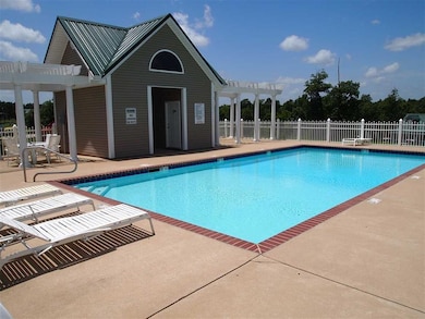 Pool with a pergola, fence, and a patio area
