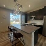 Kitchen featuring a breakfast bar, decorative back