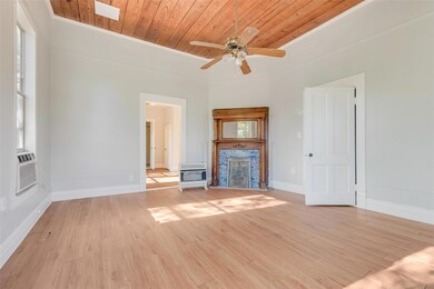 Unfurnished living room featuring light hardwood / wood-style flooring, ceiling fan, crown molding, and wood ceiling