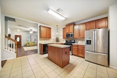 Look at this BEAUTIFUL kitchen!!! Kitchen ISLAND, STAINLESS STEEL APPLIANCES, TILE throughout, and PLENTY of counter and cabinet space!!