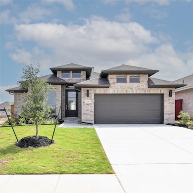 Prairie-style home with an attached garage, a fro