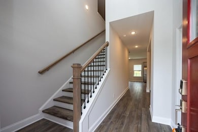 Stairs with wood finished floors and baseboards