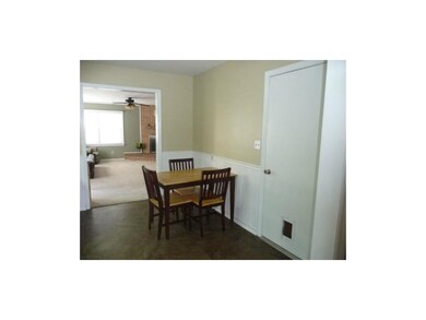 Wainscoting highlights the dining area and the kit