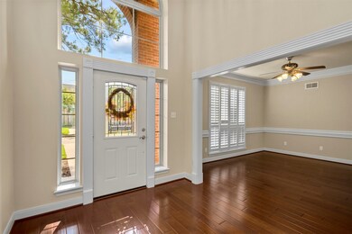 Front entrance with large Lunette window bringing lots of natural light into the home.  Dining room to the right.