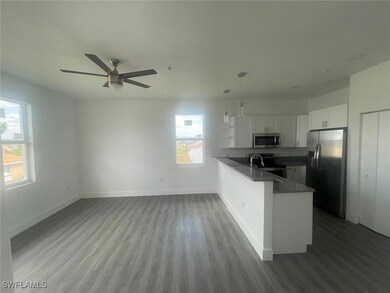 Kitchen featuring a peninsula, wood finished floor