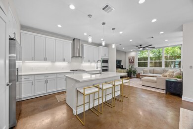 Kitchen with wall chimney range hood, finished co