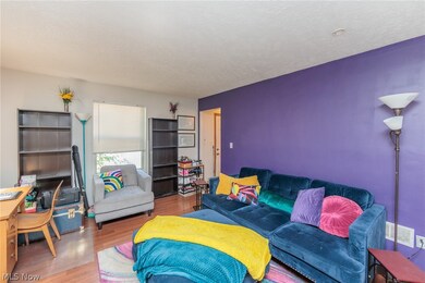 Living room featuring wood-type laminate flooringand a textured ceiling