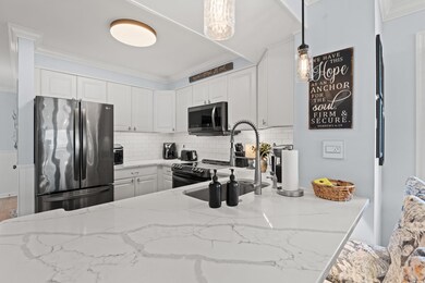 Kitchen featuring crown molding, freestanding refr
